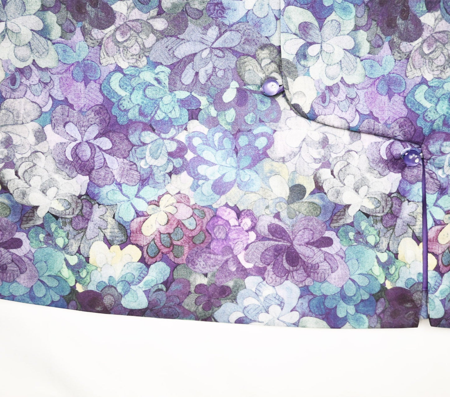 Floral patterned fabric with purple, blue, and white colors on a white background