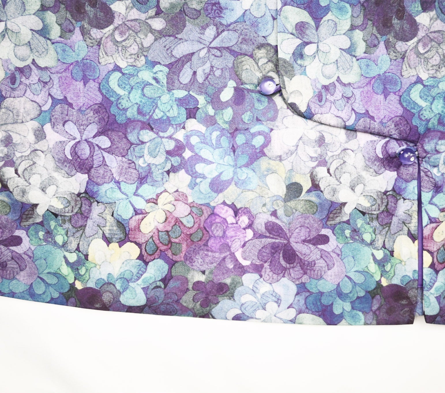 Floral patterned fabric with purple, blue, and white colors on a white background