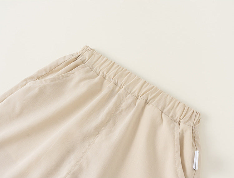 Beige pants with a tag on a light beige background
