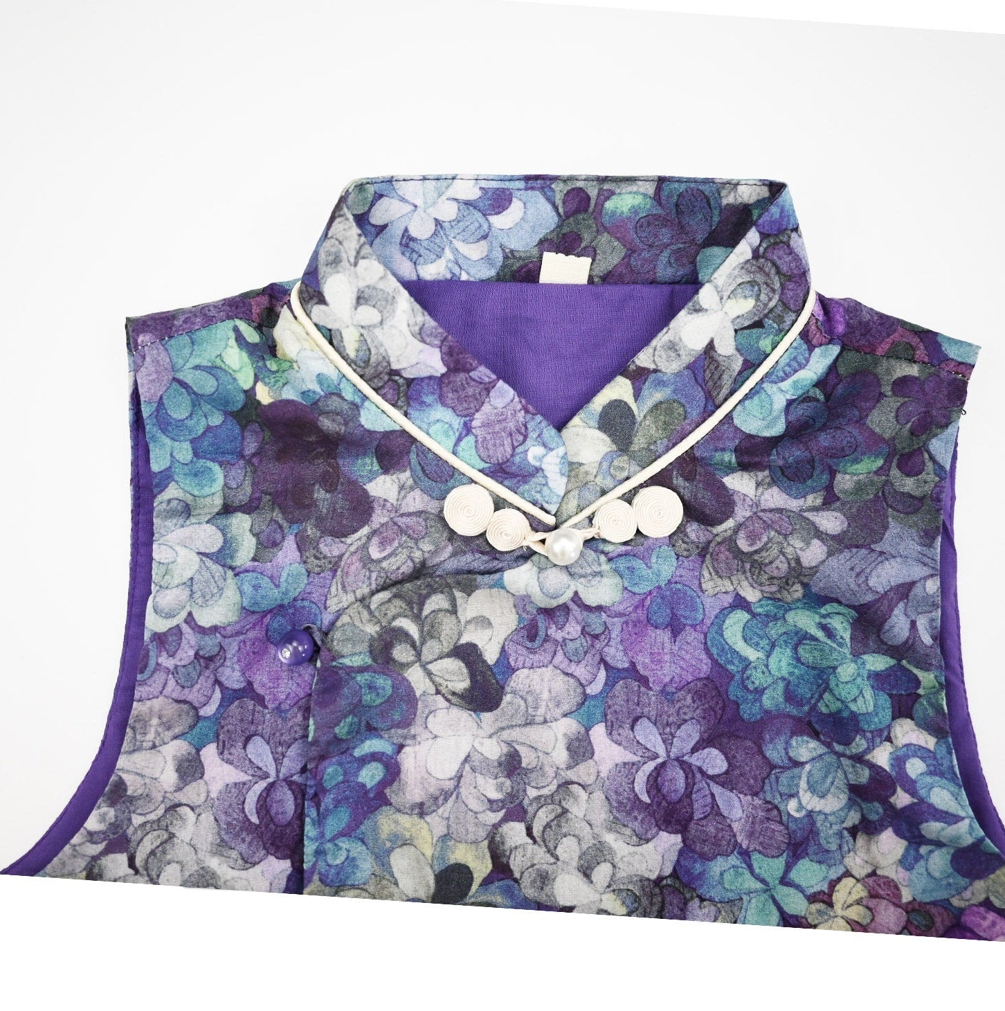 Floral-patterned garment with a purple border on a white background