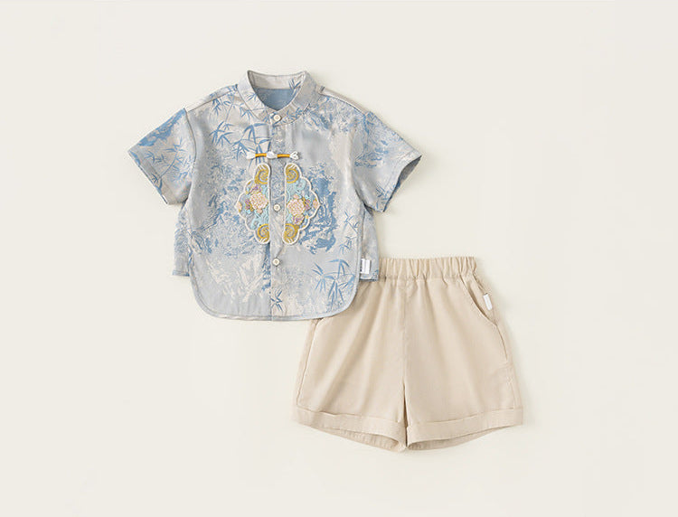 Children's outfit with a patterned shirt and beige shorts on a white background