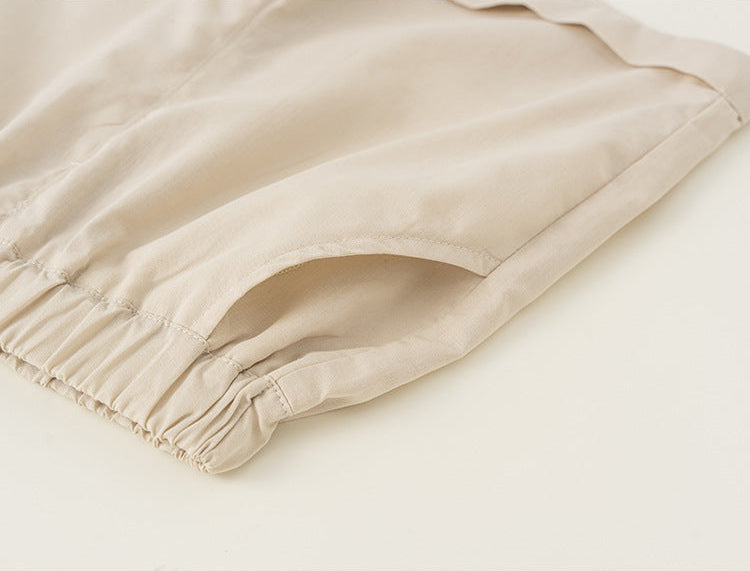 Close-up of beige fabric with a gathered hem on a white background
