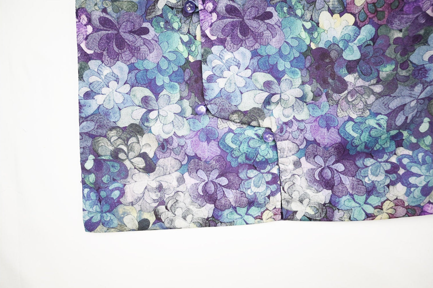 Floral patterned fabric with purple and blue colors on a white background