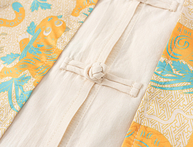 Traditional garment with a belt and colorful tiger pattern on a yellow background