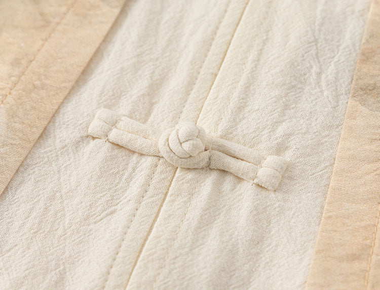 Close-up of a textured fabric with a knot detail, likely from a garment.