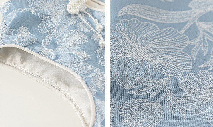 Floral lace fabric on a blue background with white embroidery